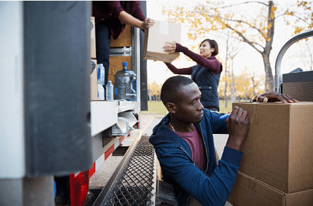 personnes chargeant et déchargeant des cartons de déménagement d'un camion